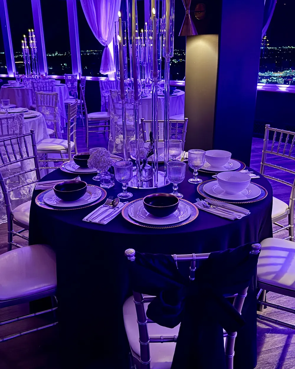 A candelabra on black linen against the night skyline width=
