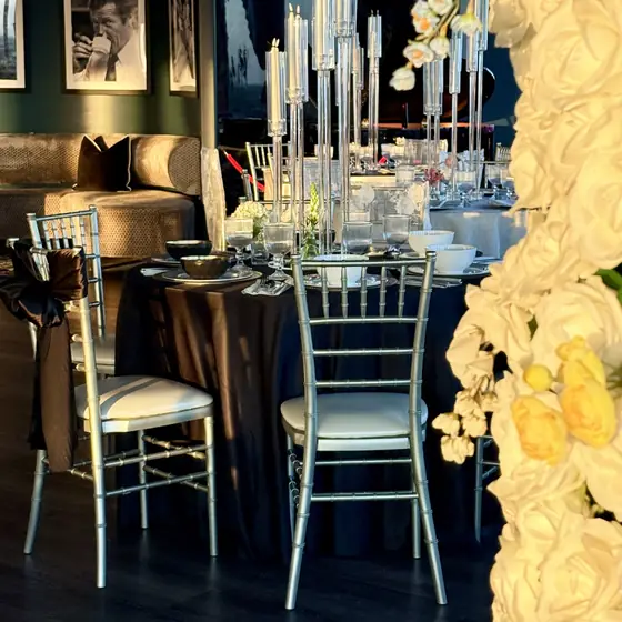 Floral wall beside a black satin round at Slate