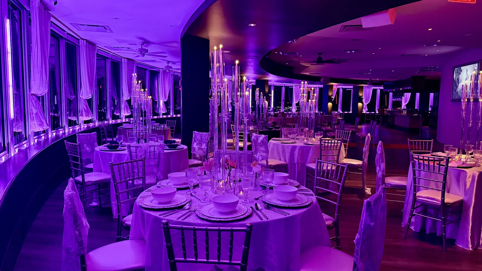 Wedding reception set with acrylic candelabras and crystal above the Oklahoma City skyline at night