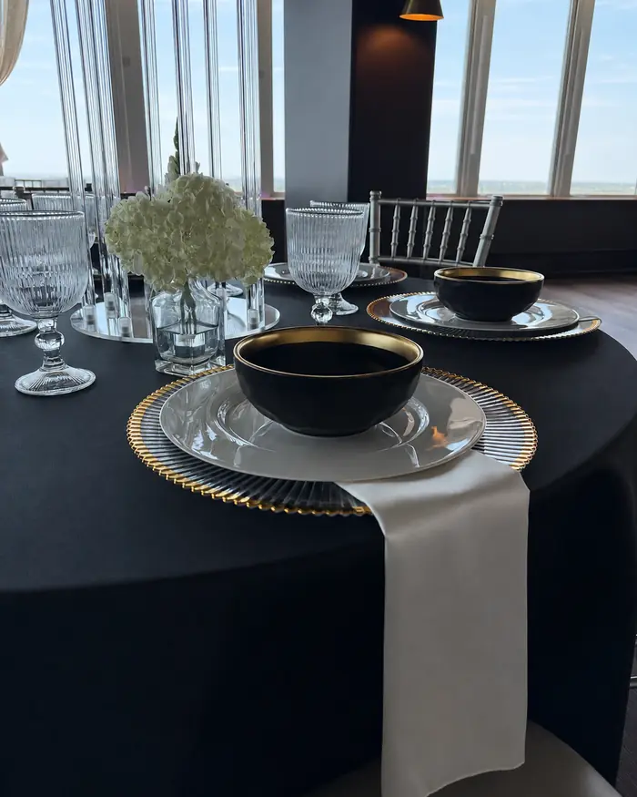 Black 120-inch round tablecloth set for six at Founders Tower, Oklahoma City
